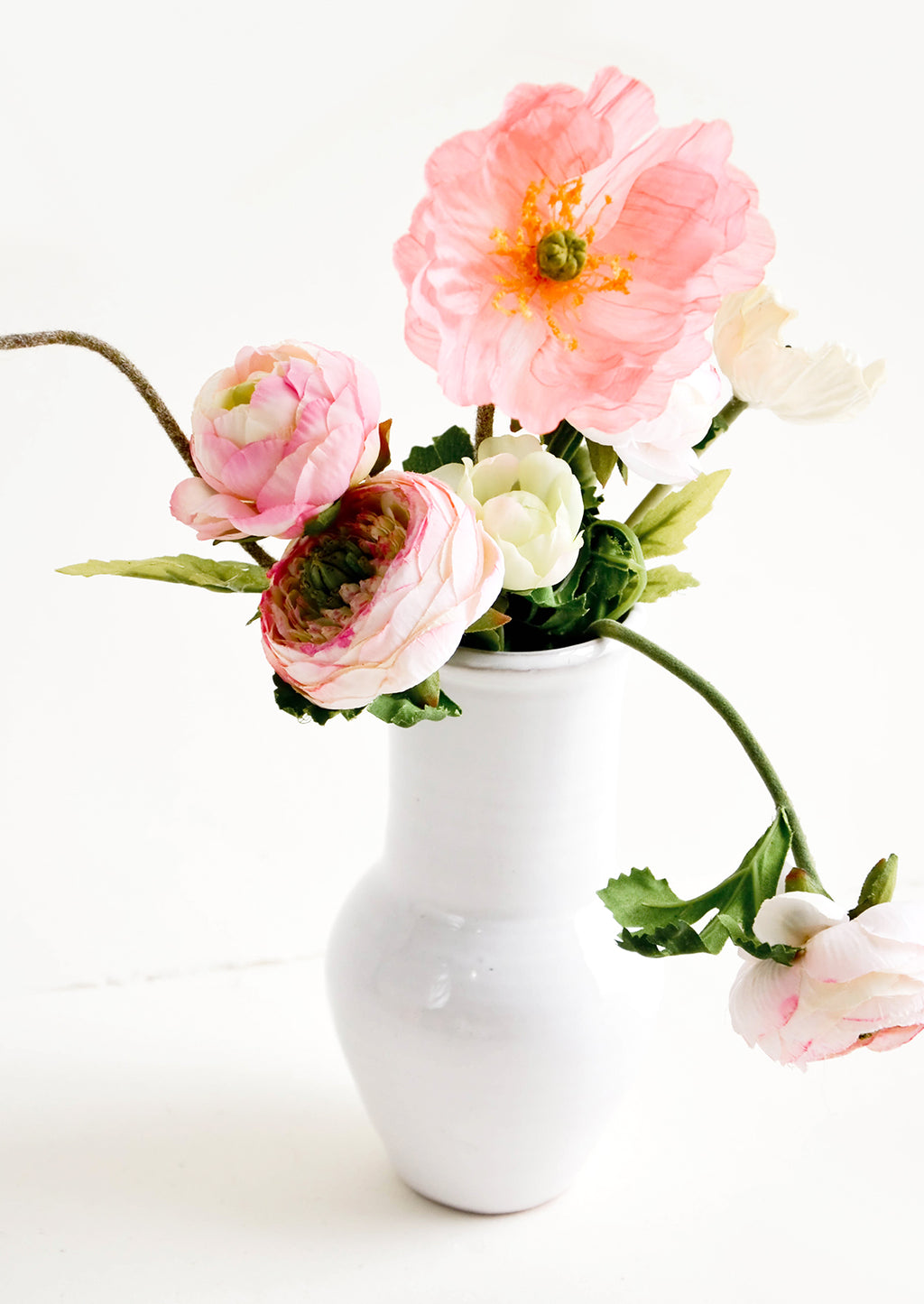 4: Glossy white ceramic vase with wide bottom and tapered top, with floral arrangement