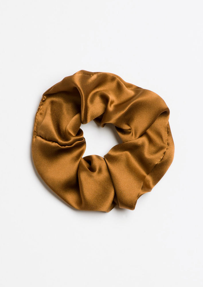 A silk scrunchie in brown.