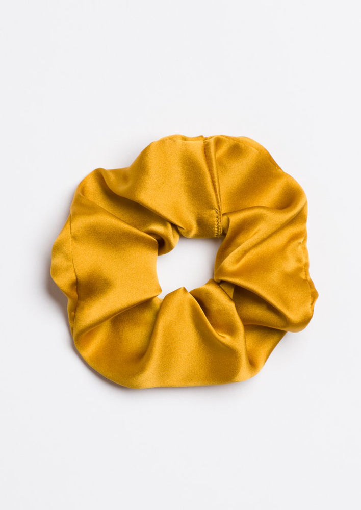 A silk scrunchie in goldenrod yellow.