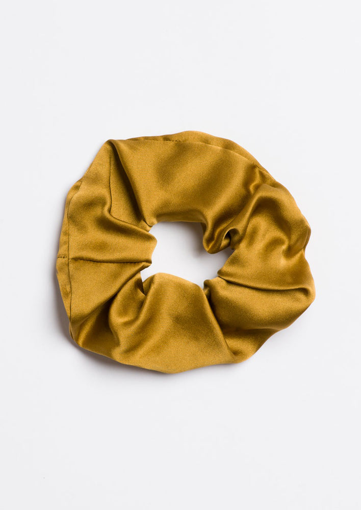 A silk scrunchie in ochre.