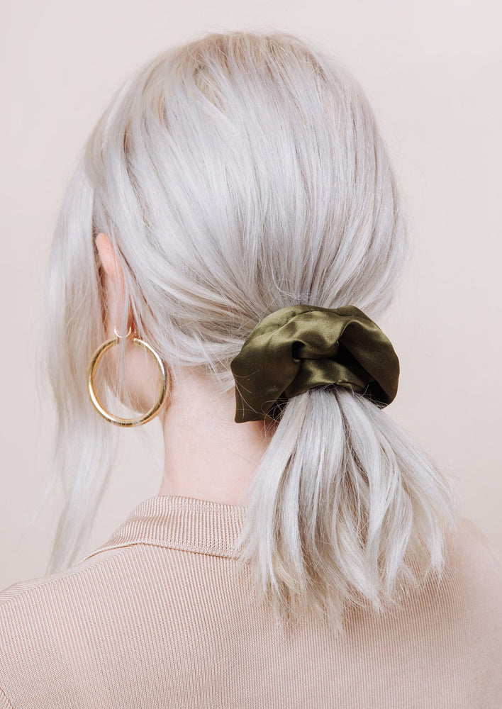 A woman with silk scrunchie in her hair.