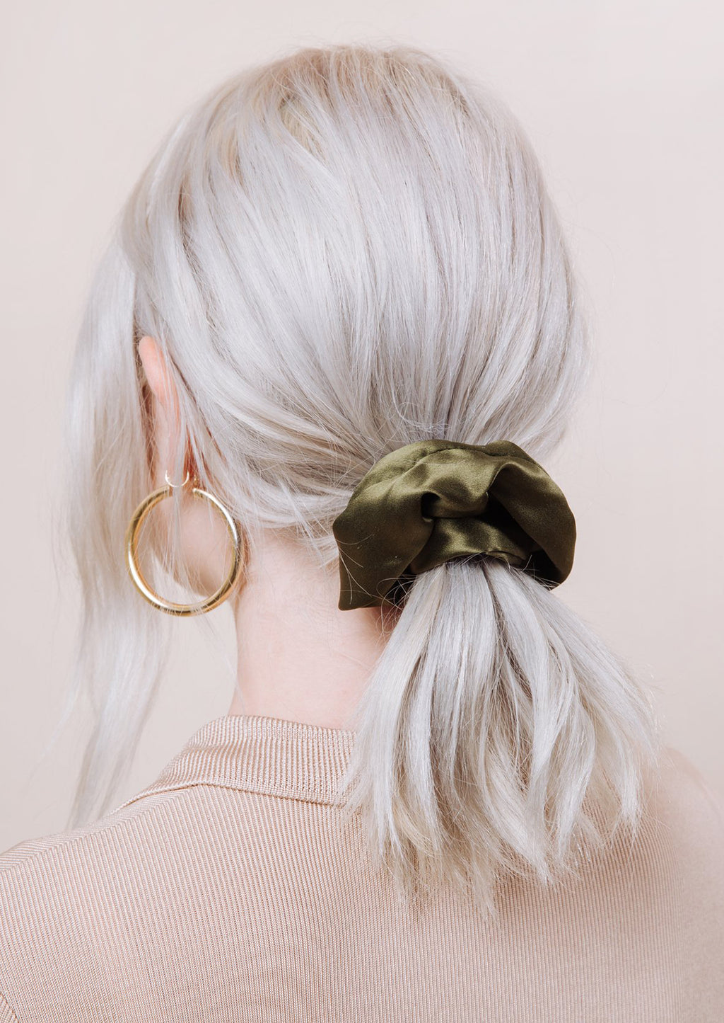 3: A woman with silk scrunchie in her hair.