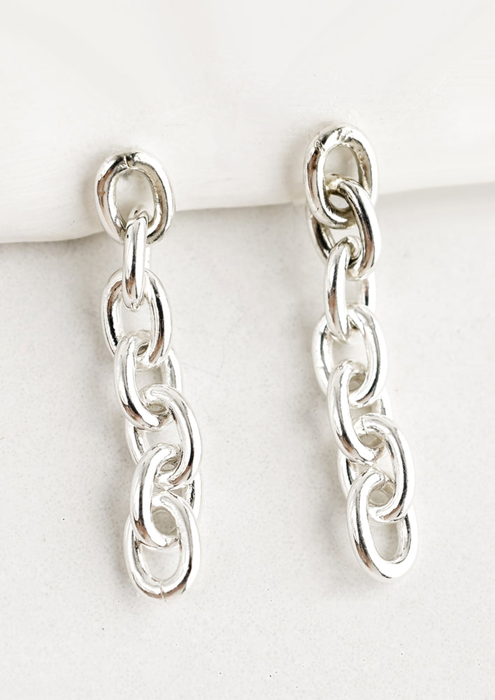 1: A pair of sterling silver chainlink drop earrings.