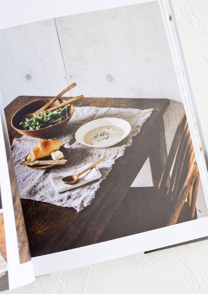 A book open to a page with a photo of a table setting.