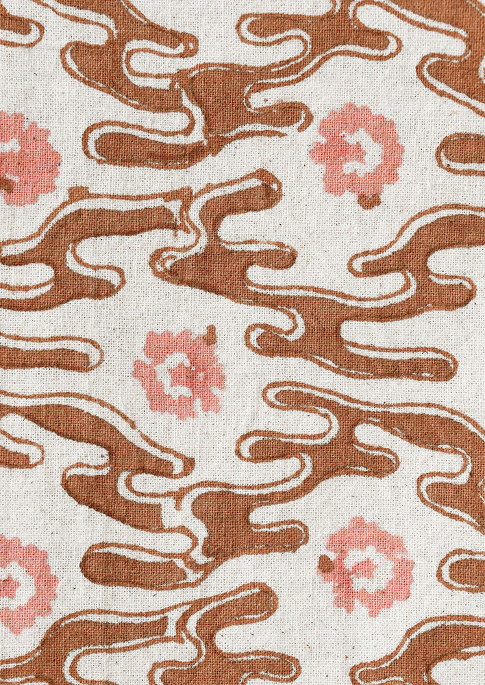 2: A brown wavy shape print with peach flowers.
