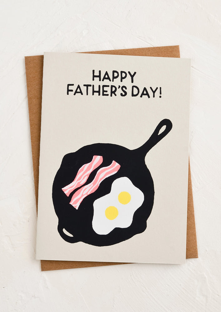 A greeting card with image of eggs and bacon in a pan.