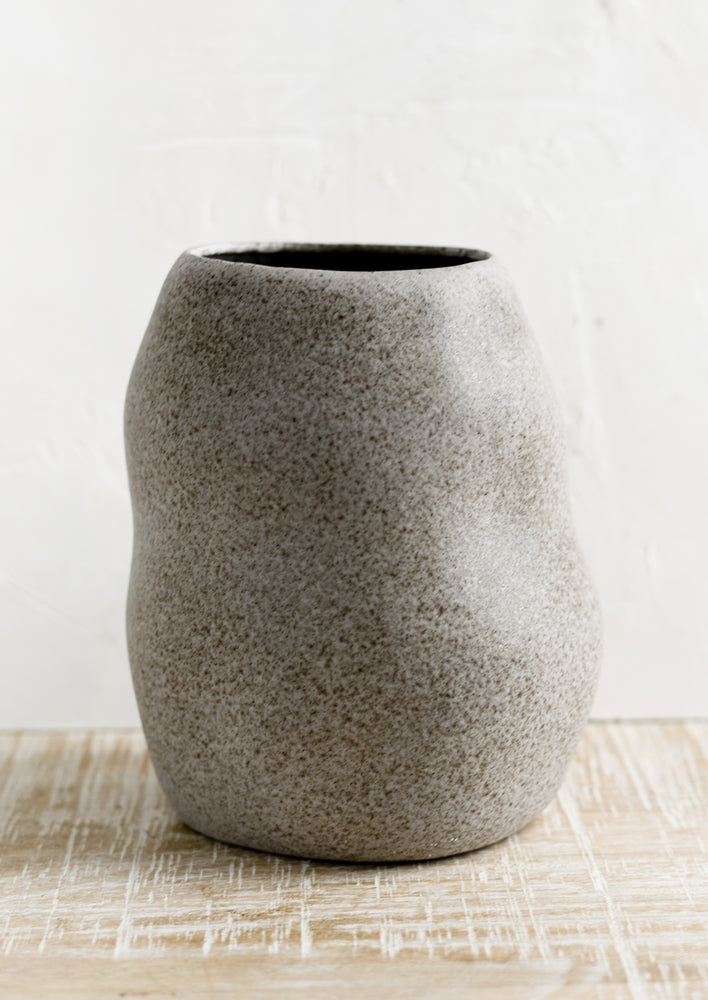Tall: An asymmetrical shaped ceramic planter in matte, speckled grey glaze.