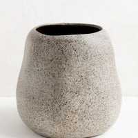 2: An organically shaped ceramic planter in matte, speckled grey glaze.