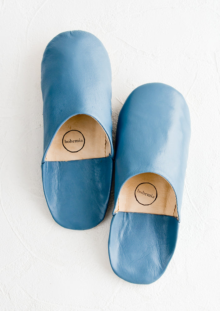 A pair of leather house slippers in marine blue.
