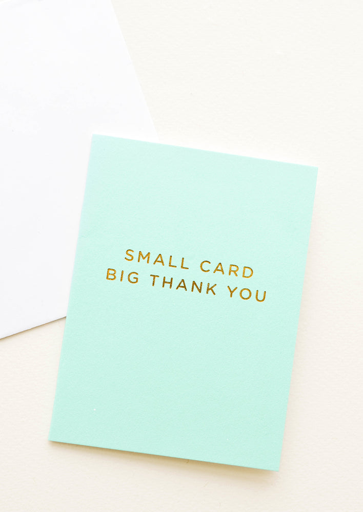 1: An aqua colored greeting card with gold foil text reading "small card big thank you."