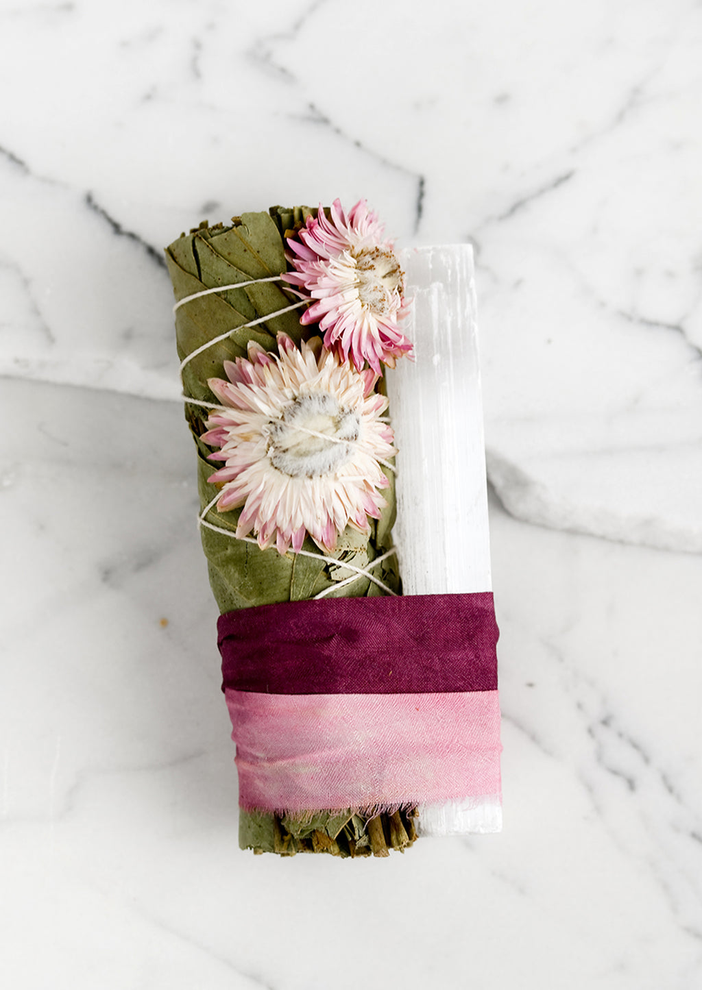 Pink Multi: A eucalyptus and selenite smudge bundle bound with pink ribbon.