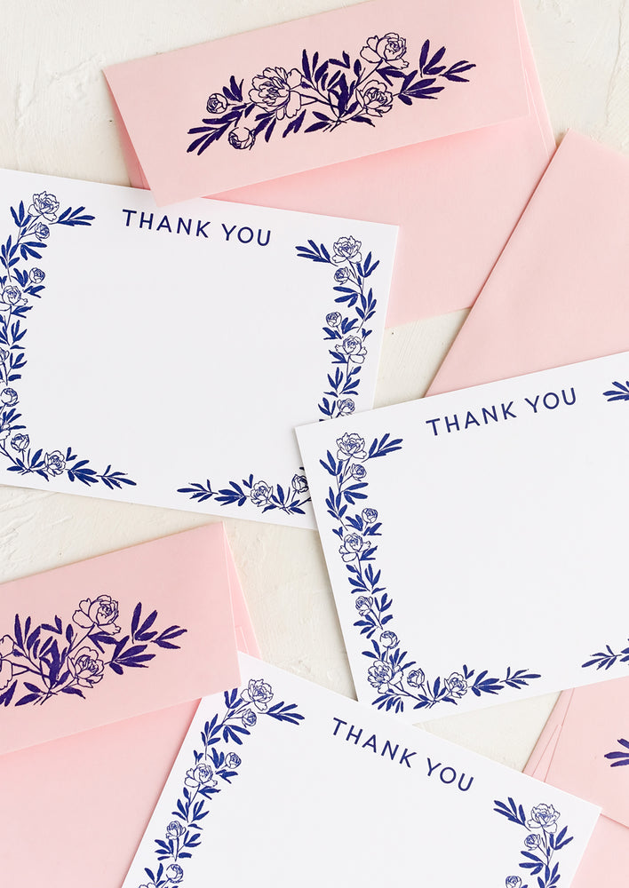 1: A set of white flat notecards with peony border and "Thank you" written at top.