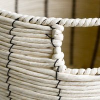 3: A round belly shaped basket in natural cord with thin black vertical stripe.