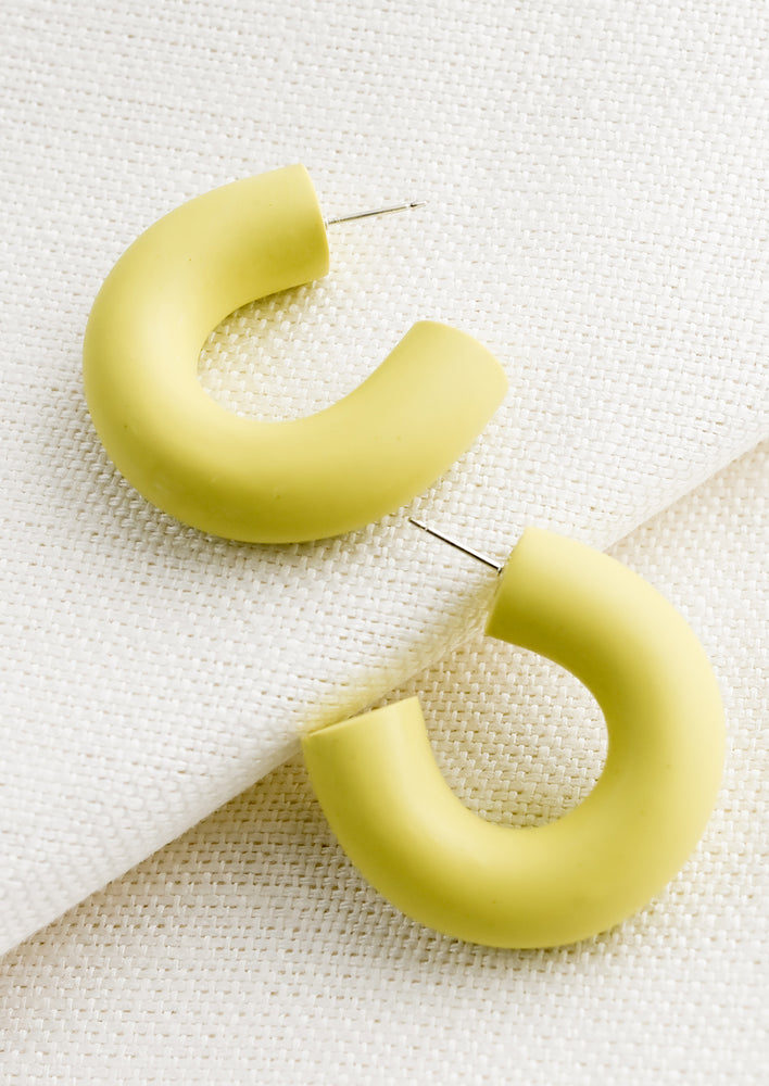 A pair of polymer clay hoop earrings in citron yellow-green.