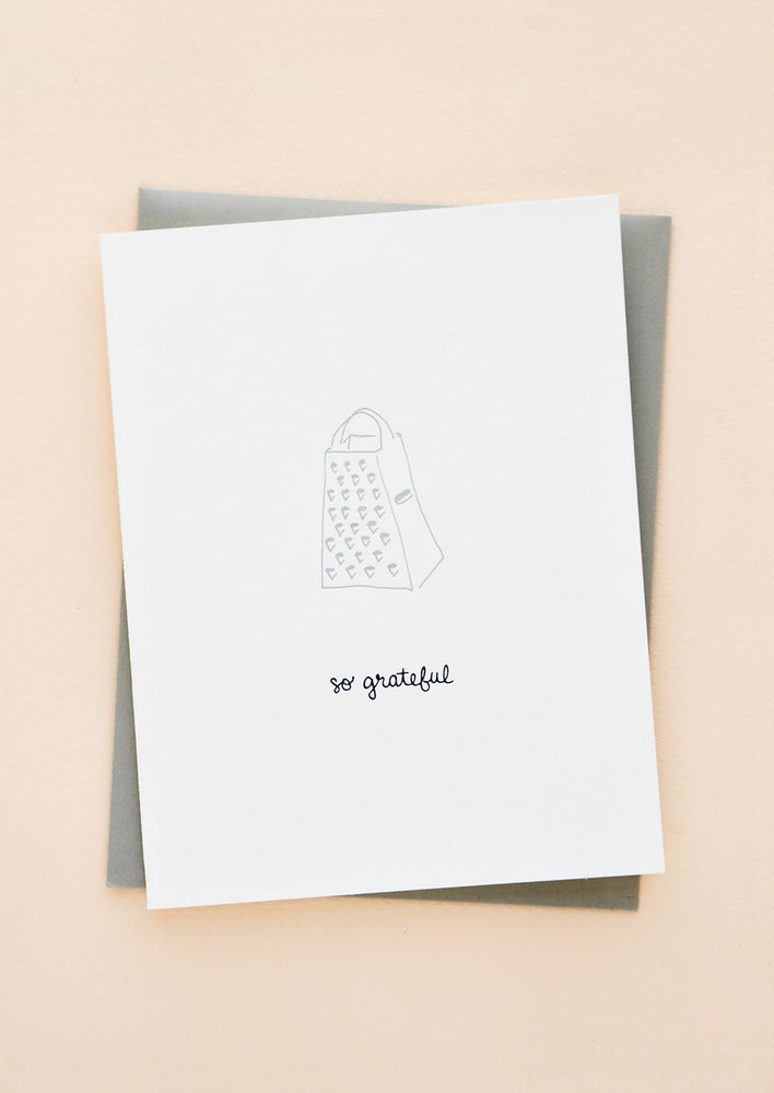 1: Greeting card with letterpress printed grater and black cursive text reading "So grateful". With grey envelope.