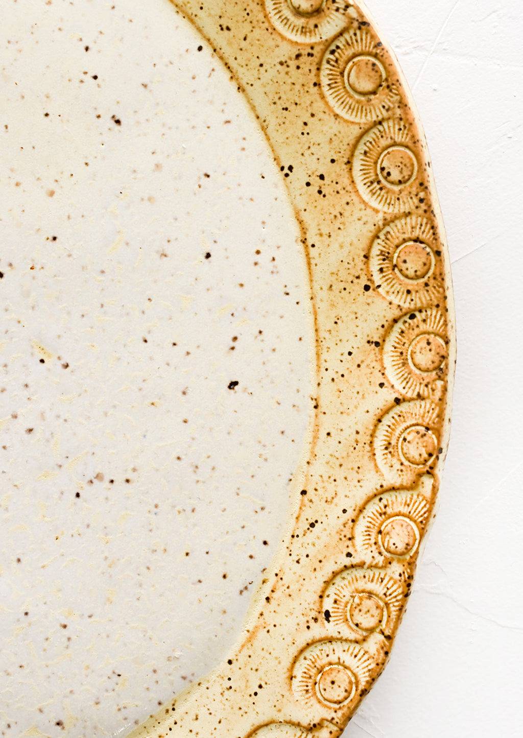 3: Detailed rim etching on ceramic platter.