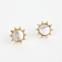 Mother of Pearl: A pair of gold stud earrings in the shape of a sun with shell inlay center and crystal "sunray" border.