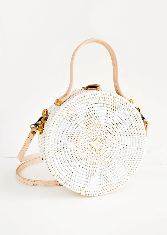 Round, canteen-style handbag woven in white rattan with tonal flower pattern and natural leather accents