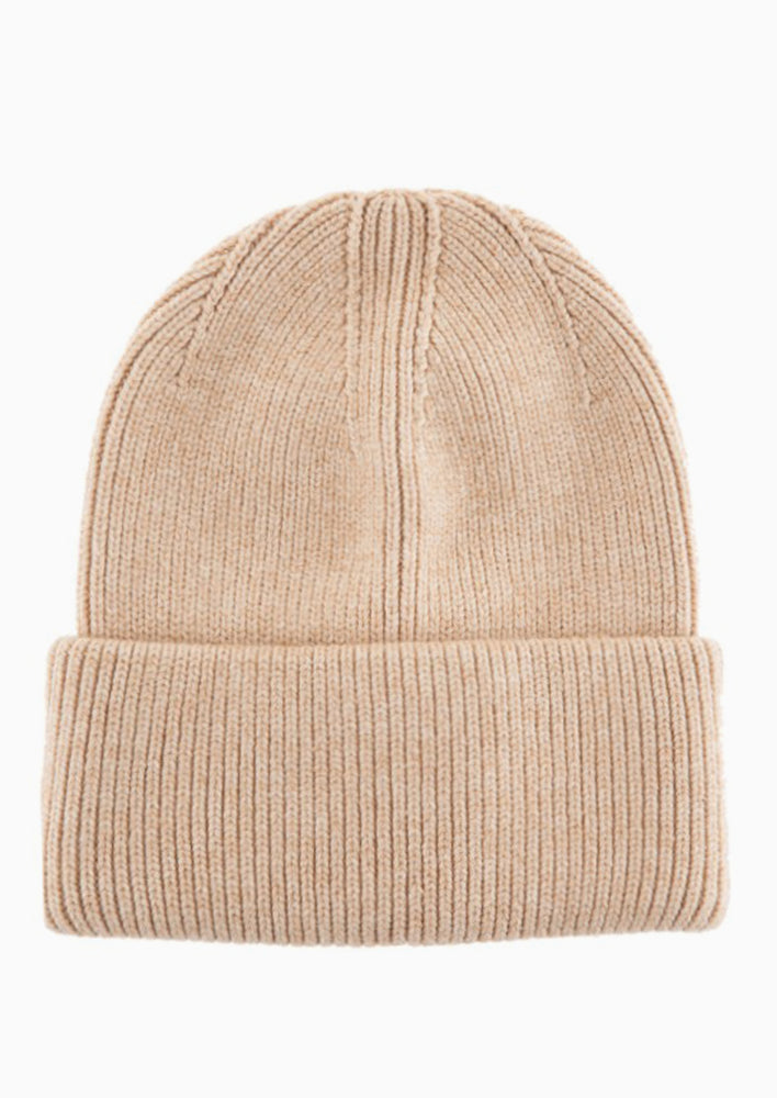 A knit beanie with oversized cuff in oatmeal color.