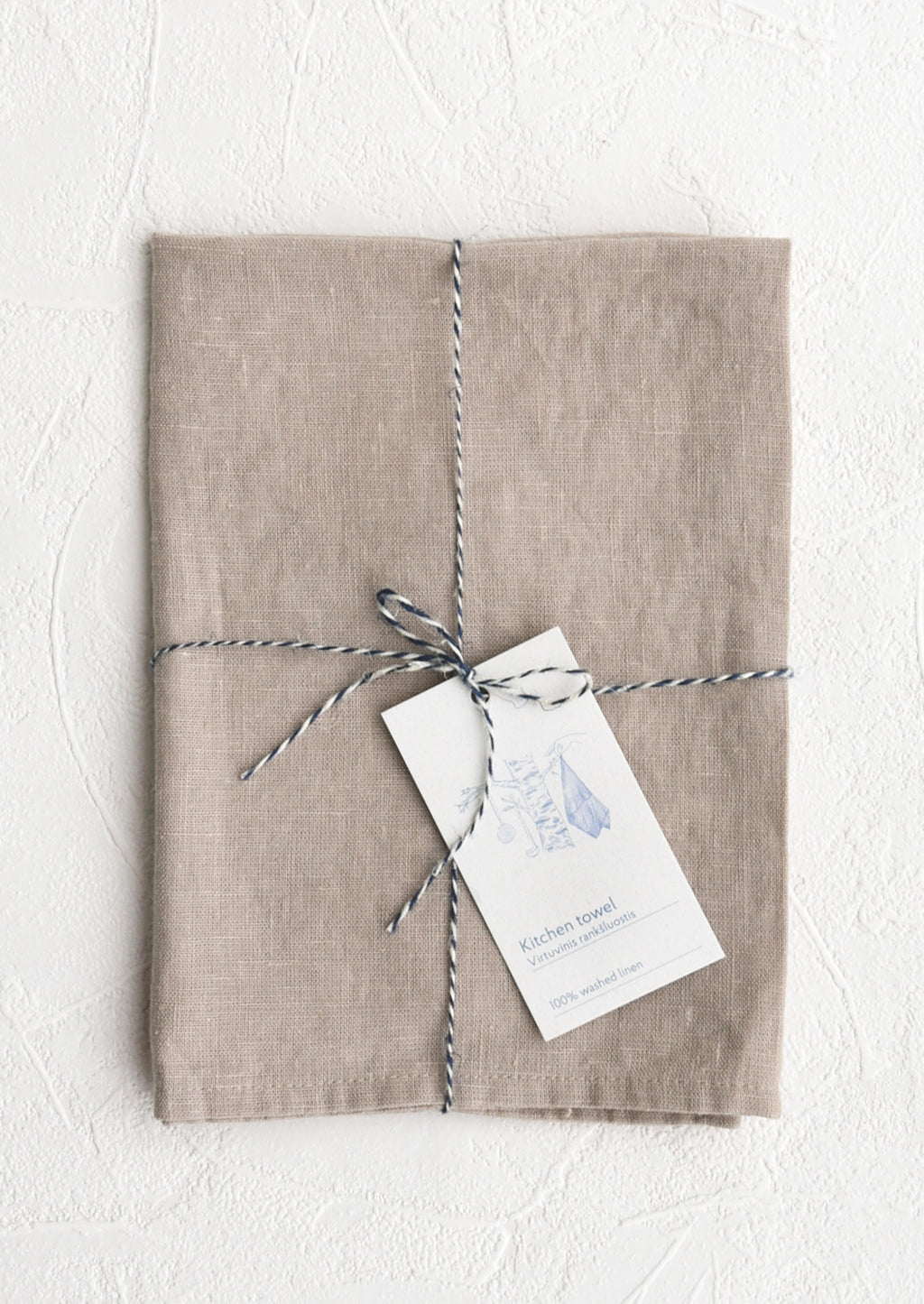 Antique Mauve: A folded faded pale mauve linen tea towel tied in baker's twine with a decorative hangtag
