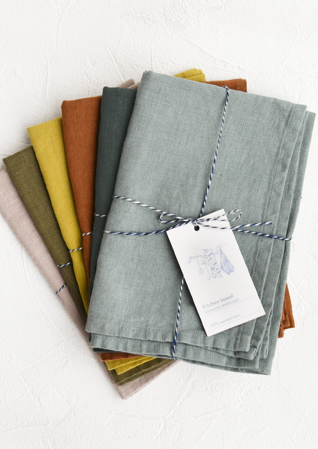 2: A stack of linen tea towels in assorted colors