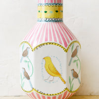 1: A graphic print vase with pink stripes and three-dimensional shape with bird motif.