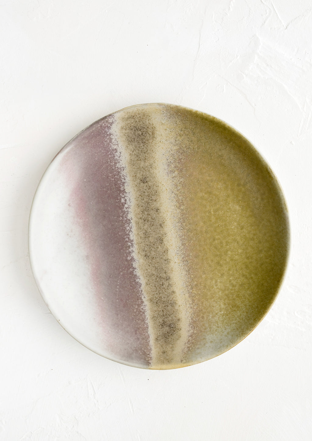 1: A round side plate with reactive glaze in mossy green-brown and grey-purple.