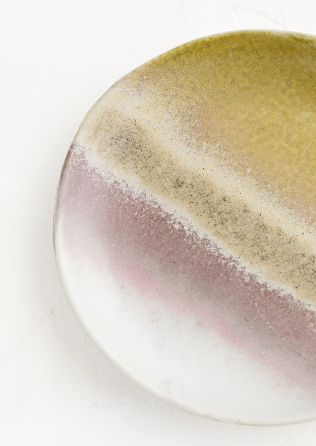 2: A ceramic plate glazed in a reactive glaze in tones of grey, mauve, brown and green.