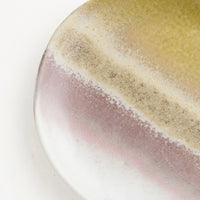 2: A ceramic plate glazed in a reactive glaze in tones of grey, mauve, brown and green.