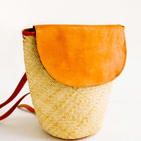 3: Woven straw backpack with leather trim and curved front flap
