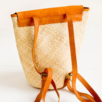 2: Woven straw backpack with tanned leather details and straps