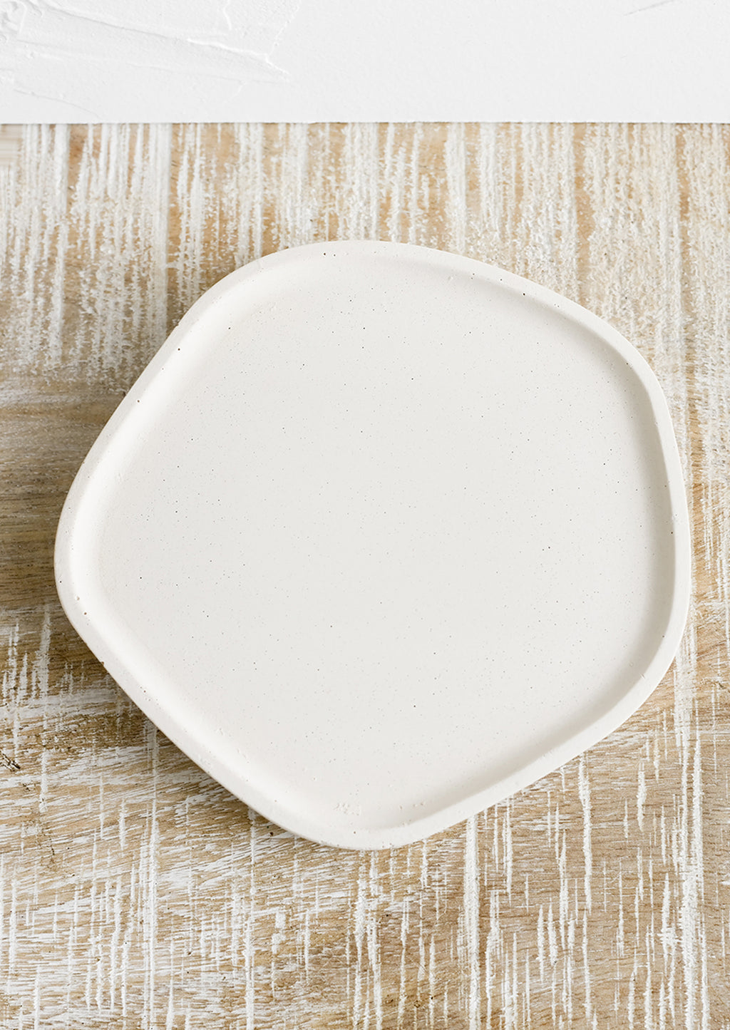 Small / Cream: A small concrete tray in asymmetrical shape in cream.