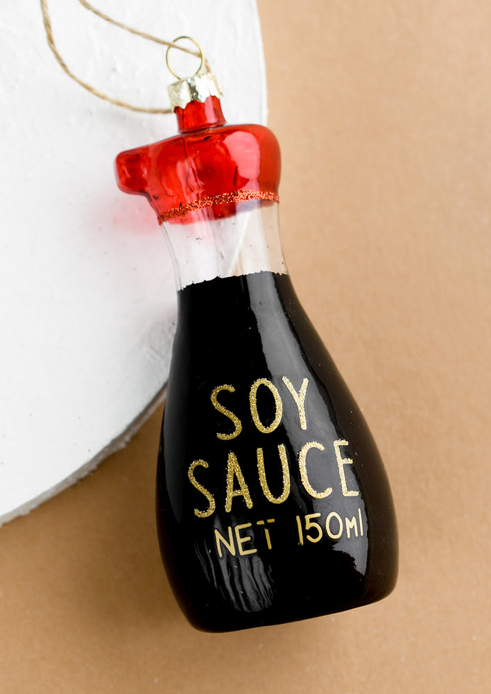 A glass ornament of a soy sauce bottle.