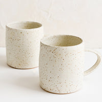 2: A pair of speckled white coffee mugs.