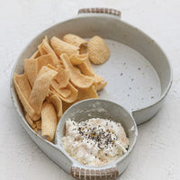 1: An asymmetrical serving dish with divided sections for chips and dip.