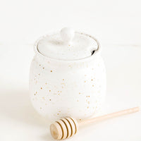 2: Round ceramic honey jar in speckled white glaze with lid and wooden dipper 