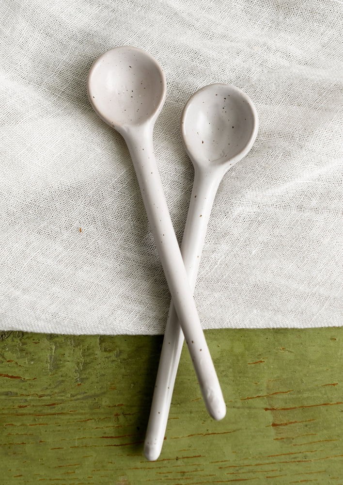 3: A stoneware spoon in white with dark speckles.