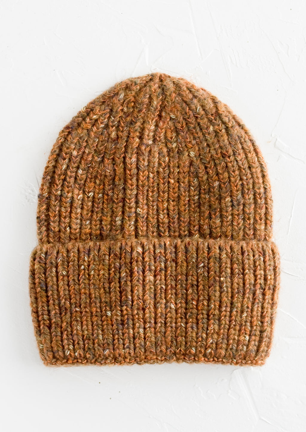 Auburn Multi: A knit beanie hat with cuffed rim made in auburn yarn with  speckles.