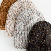 2: Four speckled yarn beanies in assorted colors.