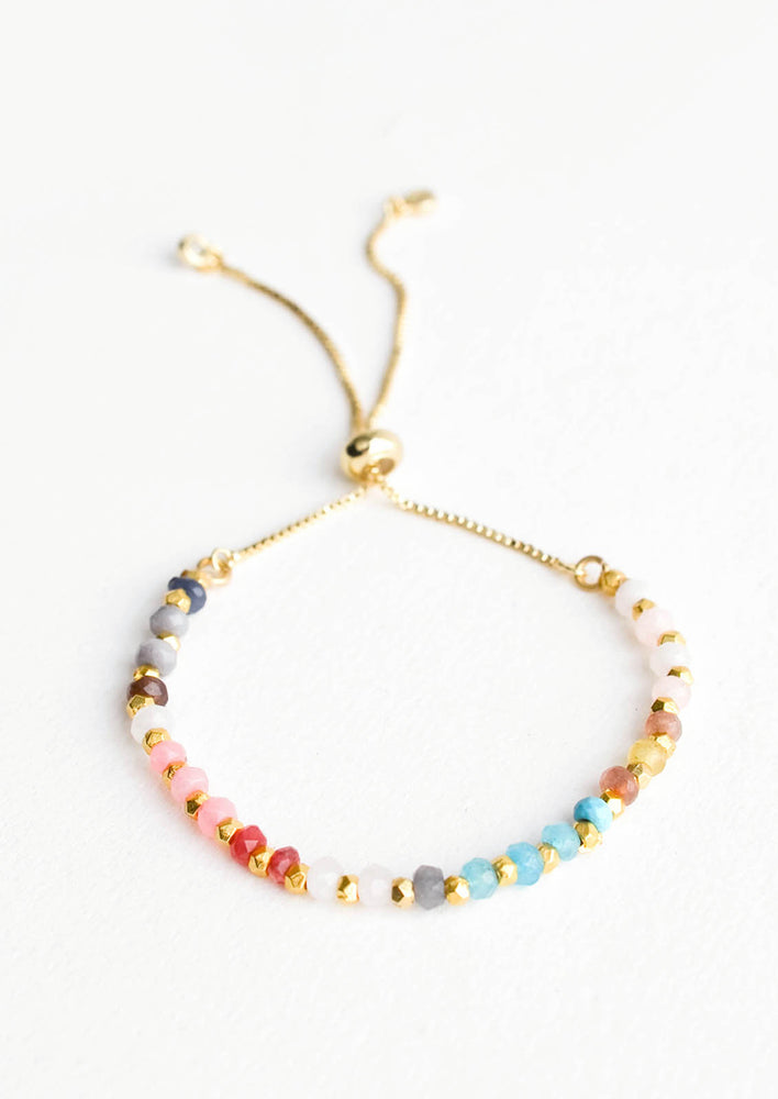 1: Beaded bracelet in a spectral array of colored gemstone beads, strung on gold chain