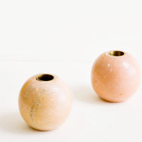 Sphere: Sphere shaped taper candle holders in pink marble with brass inlay