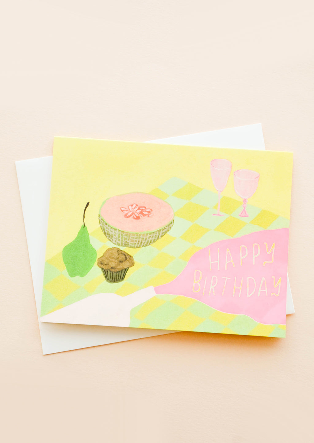 1: Greeting card with picnic setting, spilled wine puddle has letters reading "Happy Birthday"