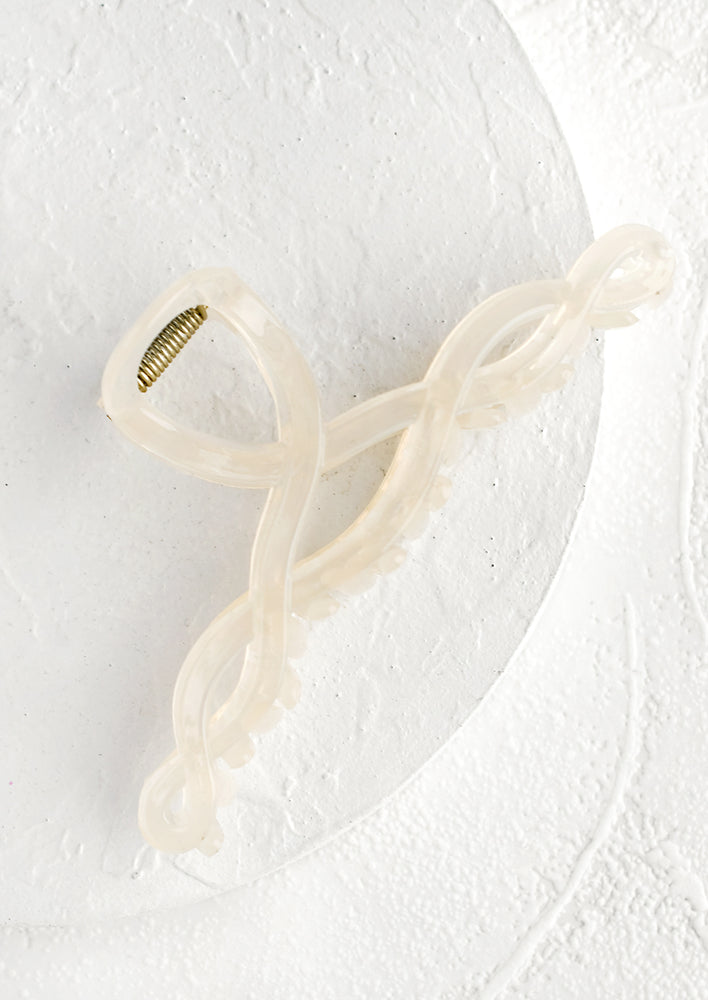 A spiral shaped hair claw in translucent white.