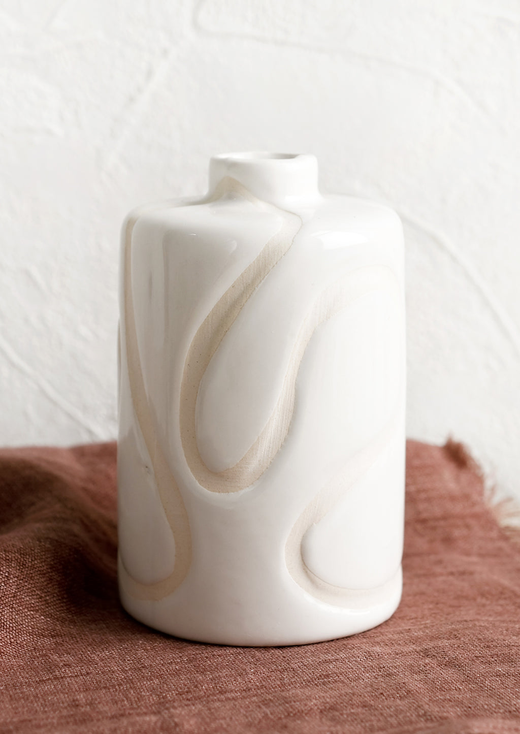 1: A glossy white ceramic vase with subtle cream squiggle design.