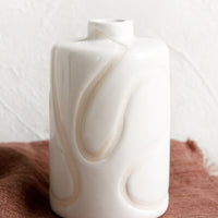 1: A glossy white ceramic vase with subtle cream squiggle design.