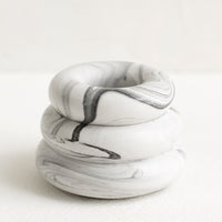 Grey Marble: A taper candle holder with 3-layer stacked donut shape in grey and white marble.