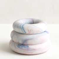 July Marble: A taper candle holder with 3-layer stacked donut shape in blue and red marble.