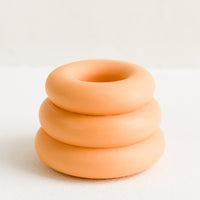 Sherbet: A taper candle holder with 3-layer stacked donut shape in sherbet orange.