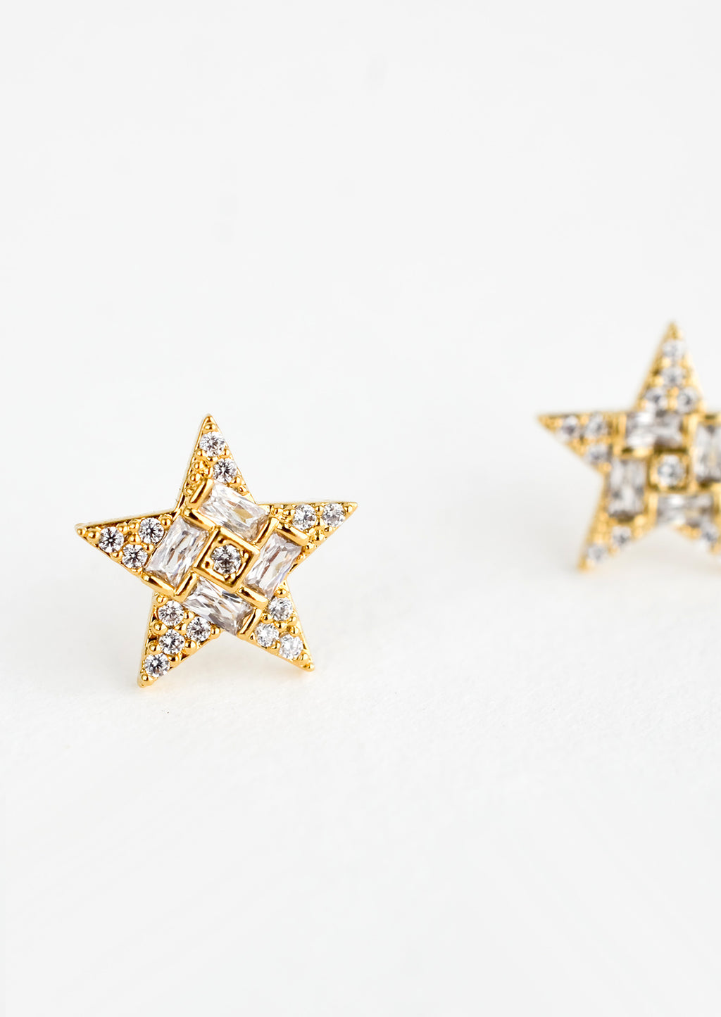 2: A pair of gold star shaped stud earrings with crystal pave detailing.