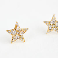 2: A pair of gold star shaped stud earrings with crystal pave detailing.